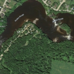 Aerial view of campground for sale near Mont-Tremblant showing the Rouge River, a private island, and surrounding forest.